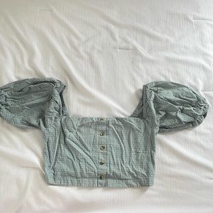 Blue/green crop top with ruffled sleeves.